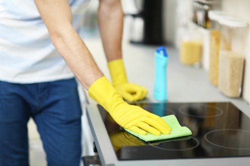 Staff applying carpet cleaning procedures safely